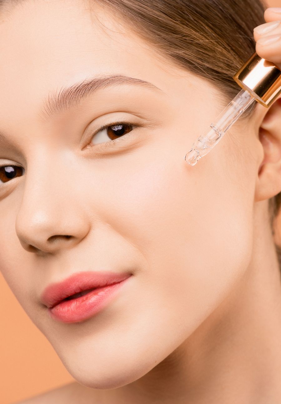 Illustrative photograph of serum being placed on the cheek.