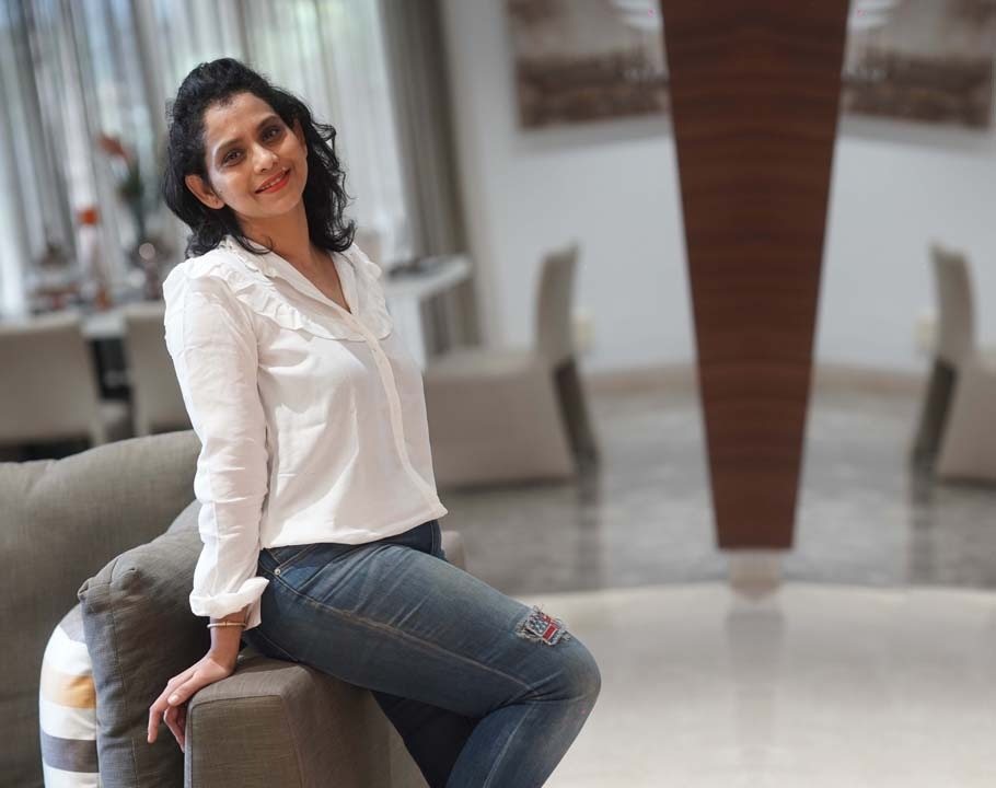 Dr. K. Sanjusha seated, in a white blouse